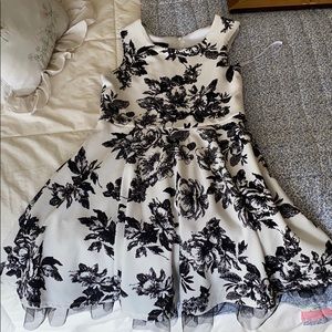 A BCX Girl dress with black floral patterns